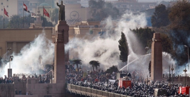 Riot police and protesters clash at the Qasr al-Nil Bridge near Tahrir Square in Cairo on Jan. 28
